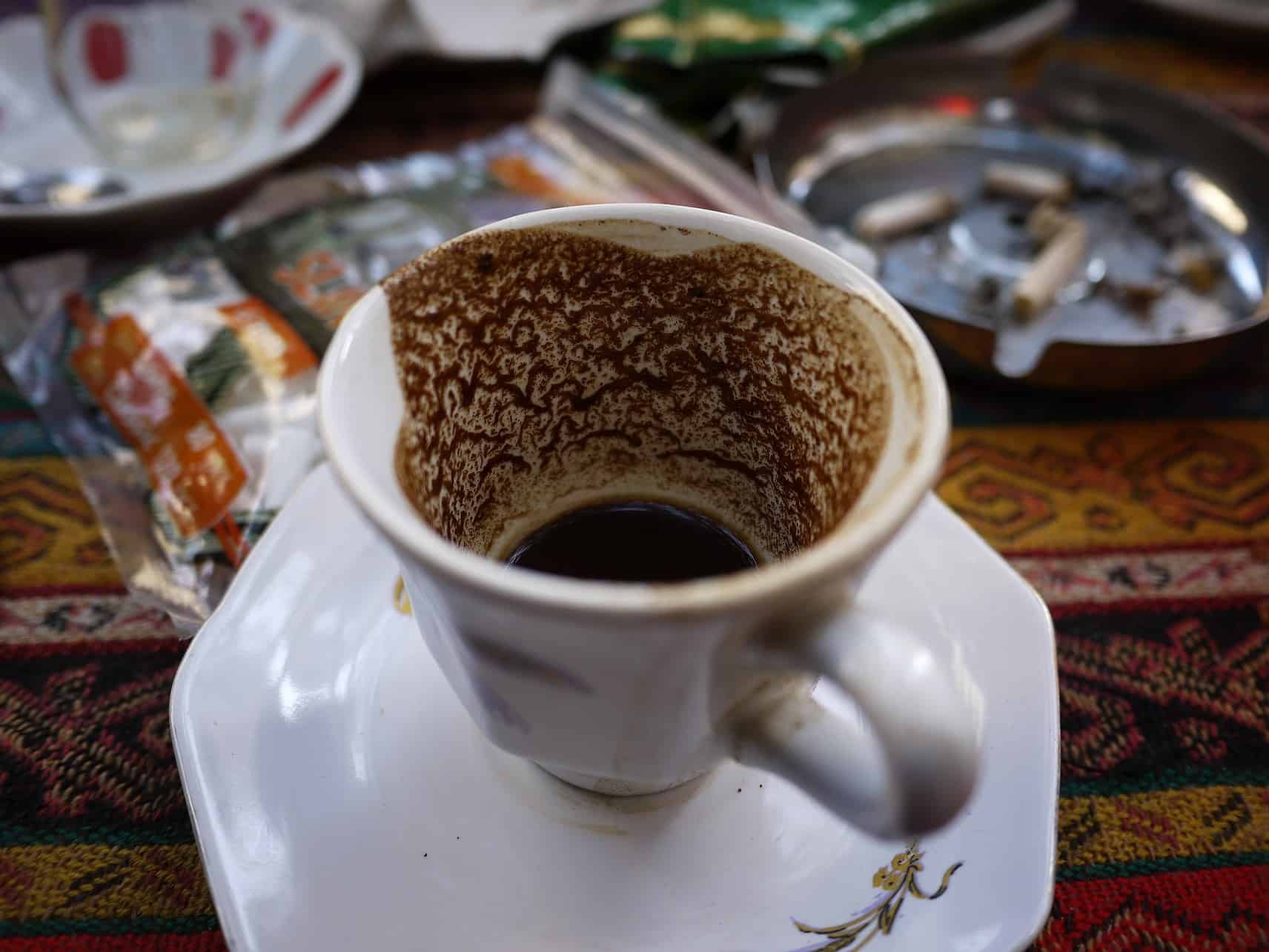 Sediment of Turkish coffee in an empty cup.